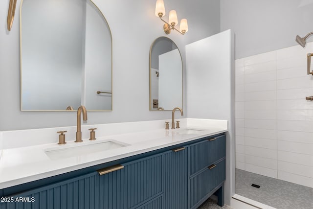 bathroom with vanity and a tile shower