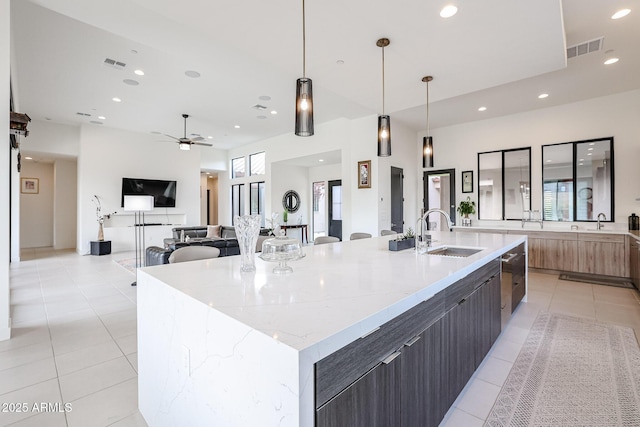kitchen featuring visible vents, modern cabinets, a sink, recessed lighting, and light tile patterned flooring