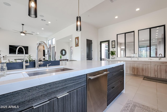 kitchen featuring open floor plan, modern cabinets, recessed lighting, a sink, and light tile patterned floors