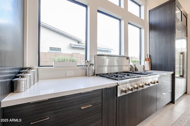 kitchen featuring light countertops, stainless steel gas cooktop, and light tile patterned floors