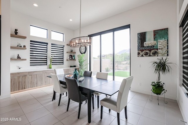 dining area with light tile patterned flooring, a chandelier, a healthy amount of sunlight, and recessed lighting