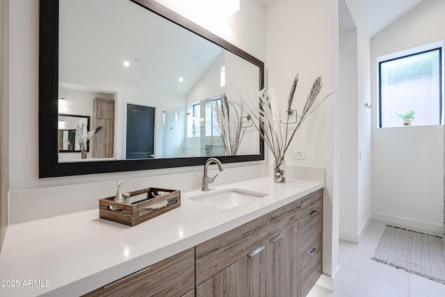 bathroom featuring vanity, lofted ceiling, baseboards, recessed lighting, and tile patterned floors