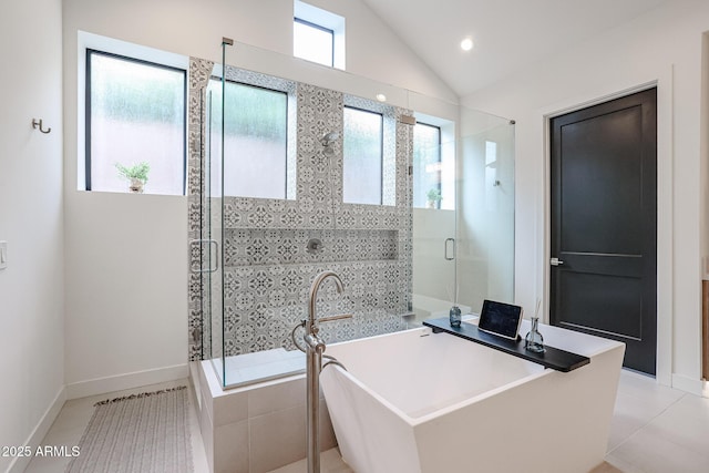 bathroom with tile patterned floors, a shower stall, a soaking tub, and lofted ceiling