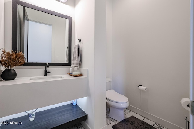 bathroom featuring toilet, baseboards, tile patterned flooring, and vanity