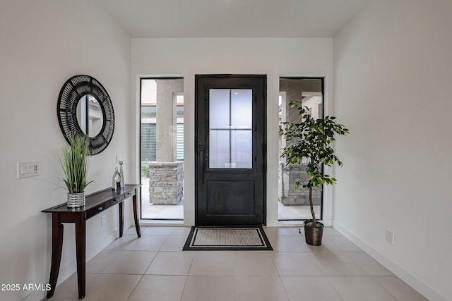 entryway featuring light tile patterned floors and baseboards