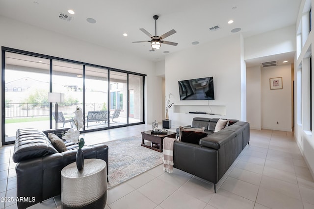living room featuring visible vents, a ceiling fan, light tile patterned floors, and recessed lighting