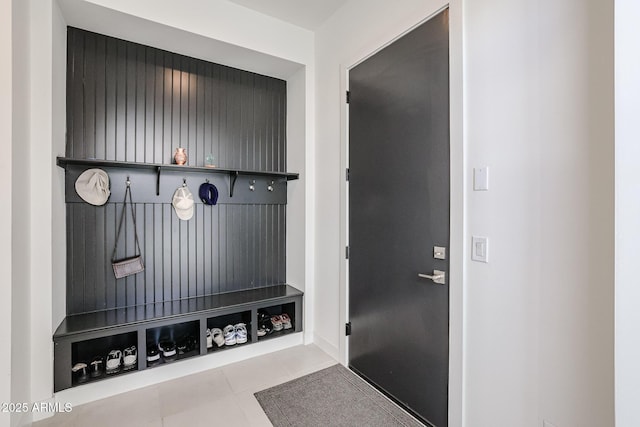 mudroom featuring baseboards and tile patterned flooring