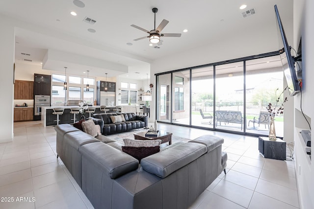 living area featuring ceiling fan, recessed lighting, light tile patterned flooring, and visible vents