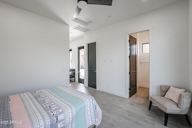 bedroom with visible vents, a ceiling fan, baseboards, and light wood-type flooring