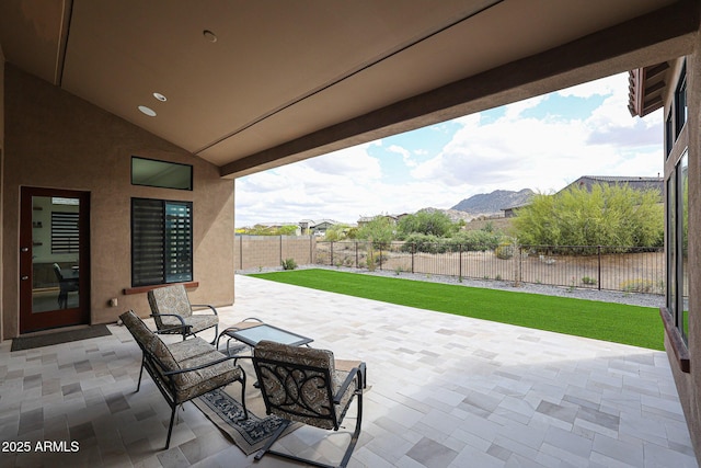 view of patio / terrace with a fenced backyard and a mountain view