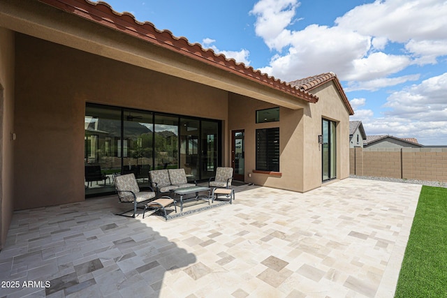 view of patio / terrace featuring fence and an outdoor living space