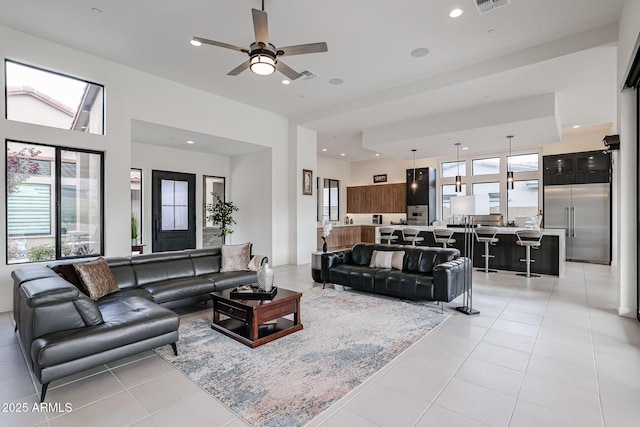living room featuring a ceiling fan, recessed lighting, light tile patterned floors, and visible vents