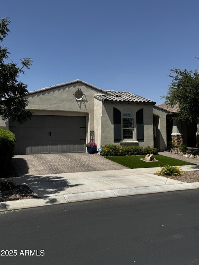 10704 E Twister Ave, Mesa, AZ 85212 - mediterranean / spanish-style house with stucco siding, driveway, a garage, a front yard, and a tiled roof