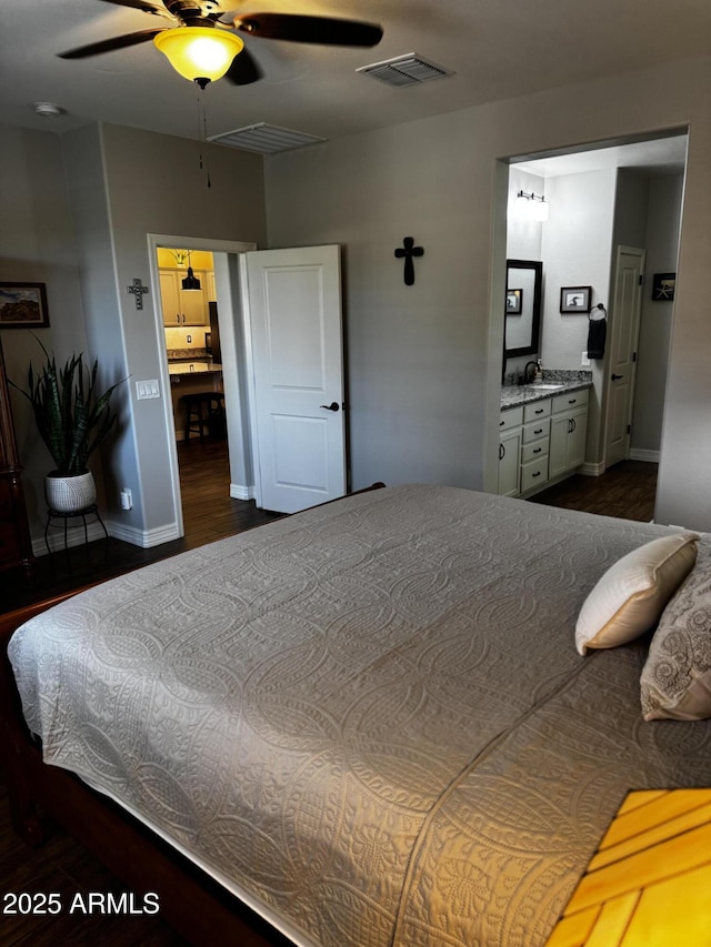 10704 E Twister Ave, Mesa, AZ 85212 - bedroom featuring wood finished floors, connected bathroom, baseboards, and a ceiling fan