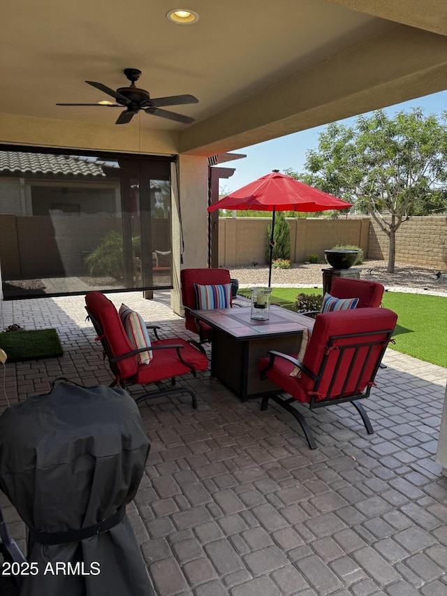 10704 E Twister Ave, Mesa, AZ 85212 - fenced backyard with a patio area, a ceiling fan, and a grill