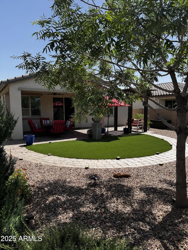 10704 E Twister Ave, Mesa, AZ 85212 - rear view of house with stucco siding, a yard, and a patio area