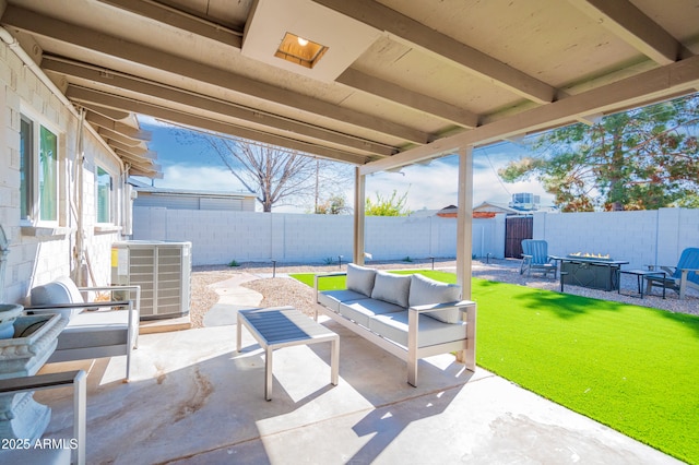 view of patio / terrace featuring cooling unit and an outdoor living space with a fire pit