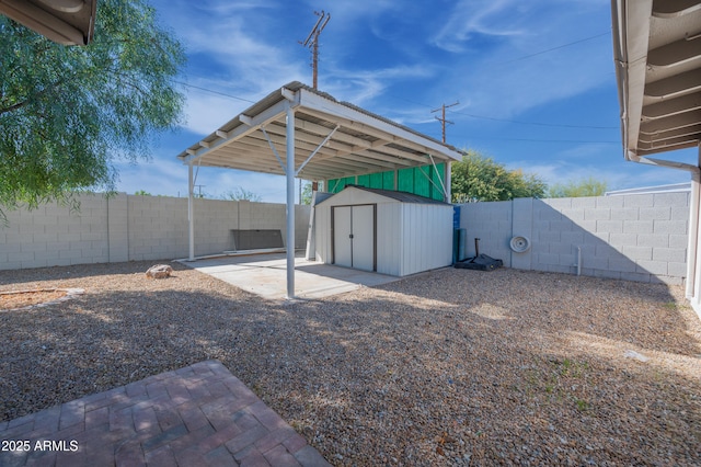 view of yard with a storage unit and a patio