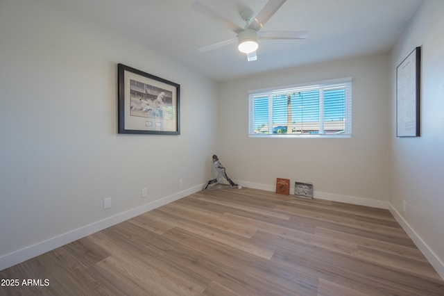 empty room featuring ceiling fan and light hardwood / wood-style flooring