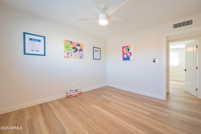 spare room with ceiling fan and light wood-type flooring