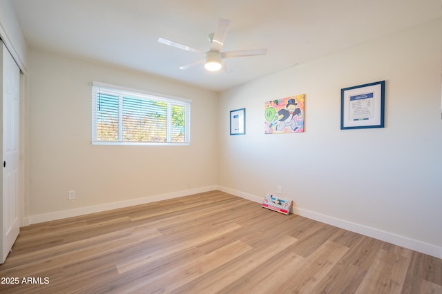 unfurnished room with ceiling fan and light wood-type flooring