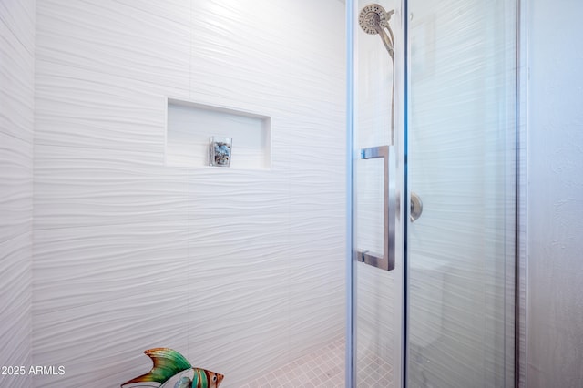 interior details featuring a shower with shower door