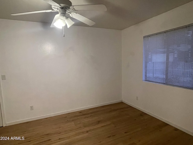 empty room featuring ceiling fan and wood-type flooring