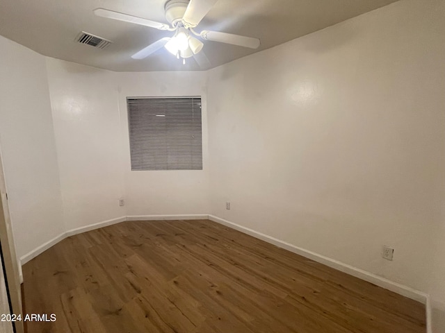 unfurnished room with ceiling fan and hardwood / wood-style flooring