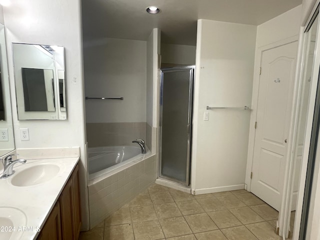 bathroom with tile patterned floors, vanity, and shower with separate bathtub