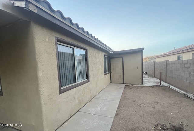 view of property exterior with a patio area