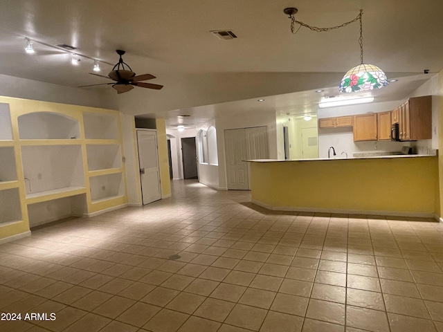 interior space featuring ceiling fan and sink