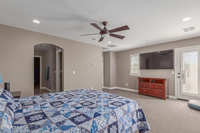 bedroom featuring visible vents, arched walkways, baseboards, access to outside, and carpet floors