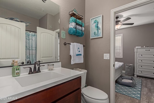 full bath featuring a ceiling fan, vanity, and toilet