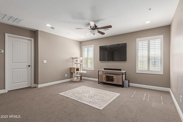 carpeted living area featuring ceiling fan, baseboards, and recessed lighting