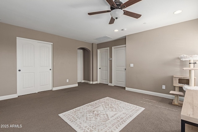 bedroom with arched walkways, carpet flooring, visible vents, and baseboards