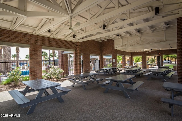 exterior space with brick wall and high vaulted ceiling