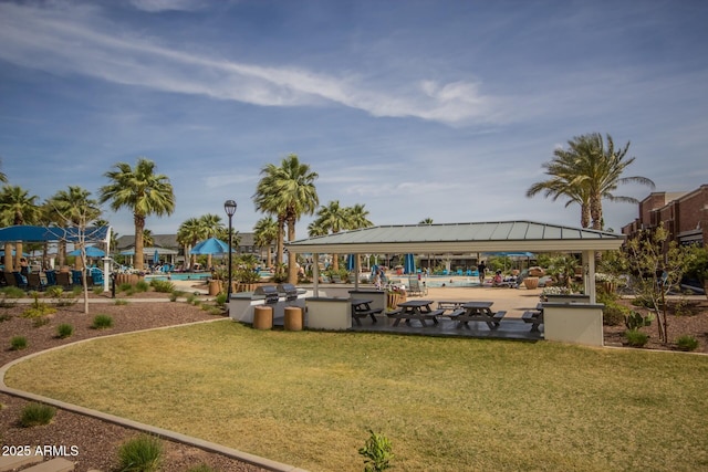 surrounding community with a pool, a yard, and a gazebo