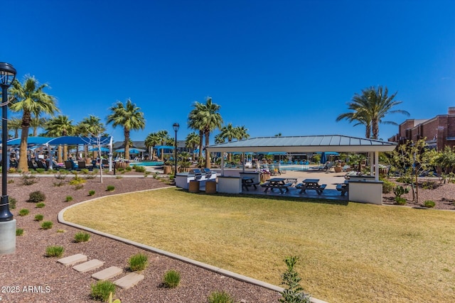 surrounding community with a lawn and a gazebo