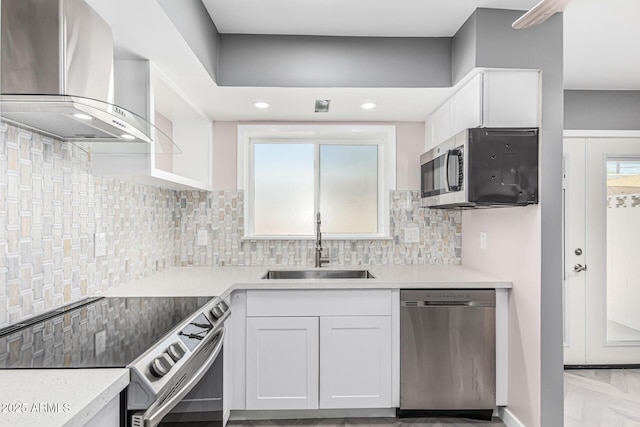 18 E Hermosa Dr Unit 18, Tempe, AZ 85282 - kitchen with stainless steel appliances, wall chimney exhaust hood, white cabinetry, backsplash, and recessed lighting