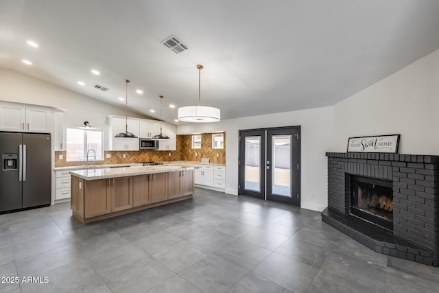 3011 E John Cabot Dr, Phoenix, AZ 85032 - kitchen featuring stainless steel appliances, lofted ceiling, tasteful backsplash, a center island, and a sink