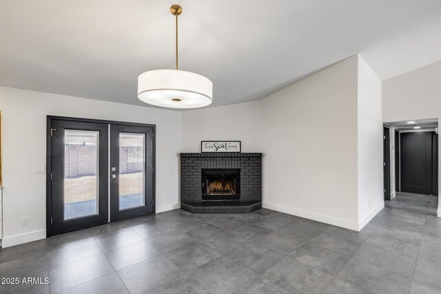 3011 E John Cabot Dr, Phoenix, AZ 85032 - unfurnished living room with french doors, baseboards, a brick fireplace, and vaulted ceiling