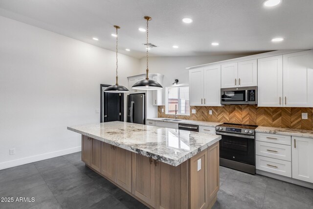 3011 E John Cabot Dr, Phoenix, AZ 85032 - kitchen with appliances with stainless steel finishes, a center island, decorative backsplash, recessed lighting, and white cabinets