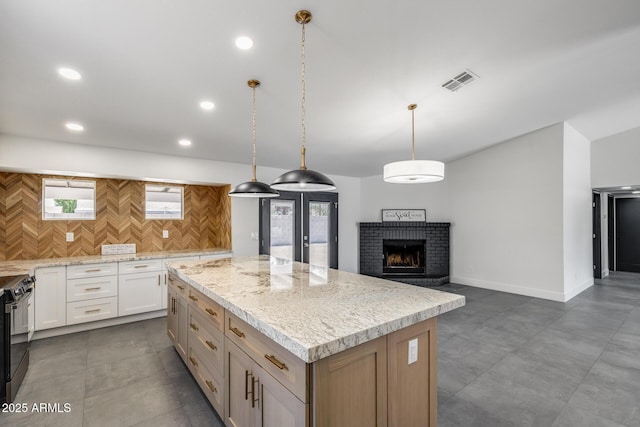 3011 E John Cabot Dr, Phoenix, AZ 85032 - kitchen featuring a center island, plenty of natural light, stainless steel range, white cabinets, and recessed lighting