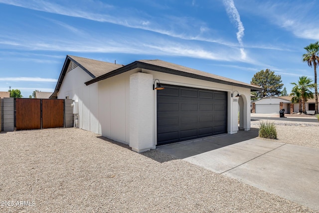 3011 E John Cabot Dr, Phoenix, AZ 85032 - garage featuring driveway and a gate