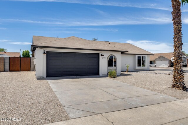 3011 E John Cabot Dr, Phoenix, AZ 85032 - single story home featuring concrete driveway, an attached garage, stucco siding, and a shingled roof
