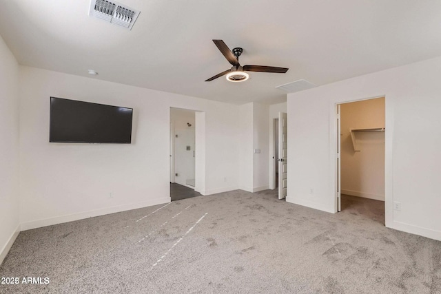 2364 N 212th Ave, Buckeye, AZ 85396 - unfurnished bedroom with carpet, baseboards, a spacious closet, and ceiling fan