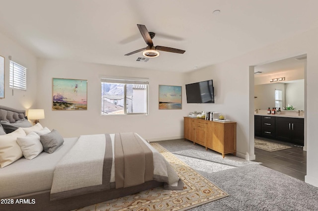 2364 N 212th Ave, Buckeye, AZ 85396 - bedroom featuring connected bathroom, baseboards, a sink, and a ceiling fan