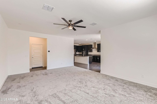 2364 N 212th Ave, Buckeye, AZ 85396 - unfurnished living room featuring dark carpet, a ceiling fan, and baseboards