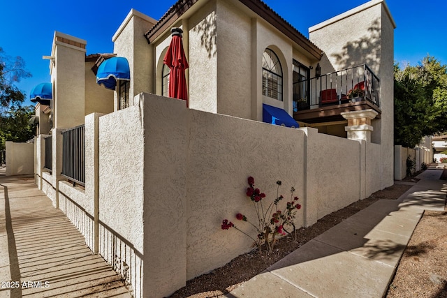 view of side of home with a balcony