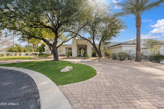 mediterranean / spanish home with a front lawn